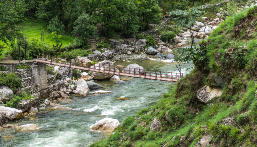 Wooden pedestrian hanging bridge over tirthan river in Tirthan Valley, Himachal Pradesh, India